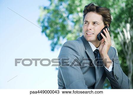 Businessman using cell phone View Large Photo Image Stock Image - Businessman using cell phone. Fotosearch