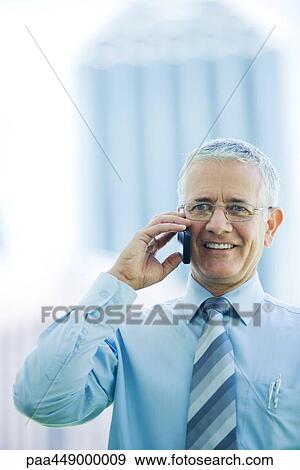 Businessman using cell phone View Large Photo Image Stock Photo - Businessman using cell phone. Fotosearch