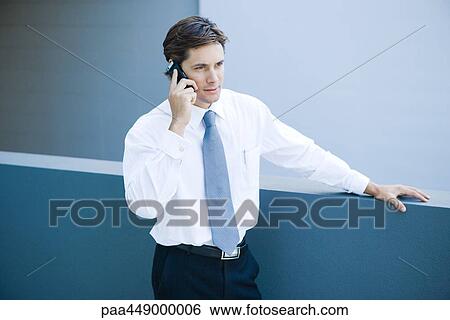 Businessman using cell phone, waist up View Large Photo Image Stock Photograph - Businessman using cell phone, waist up. Fotosearch