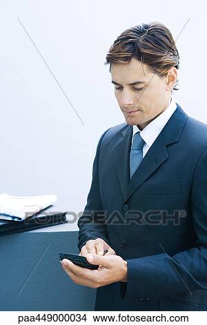 Businessman using electronic organizer View Large Photo Image Picture - Businessman using electronic organizer. Fotosearch