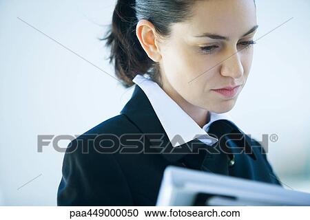 Businesswoman looking at file, cropped view View Large Photo Image Stock Image - Businesswoman looking at file, cropped view. Fotosearch