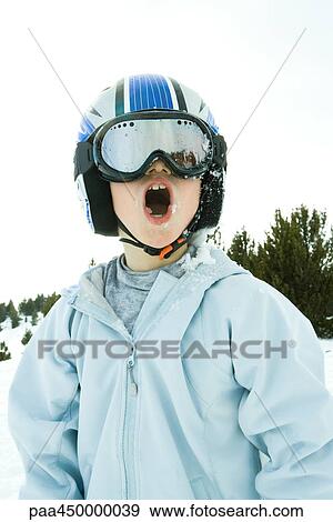 Boy wearing helmet and ski goggles, snow-covered, open mouth View Large Photo Image Stock Photo - Boy wearing helmet and ski goggles, snow-covered, open mouth. Fotosearch