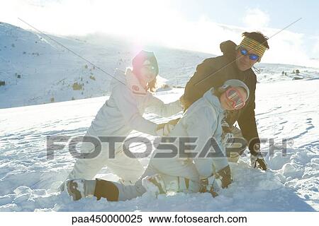 Father and two daughters crouching in snow, smiling View Large Photo Image Stock Photography - Father and two daughters crouching in snow, smiling. Fotosearch