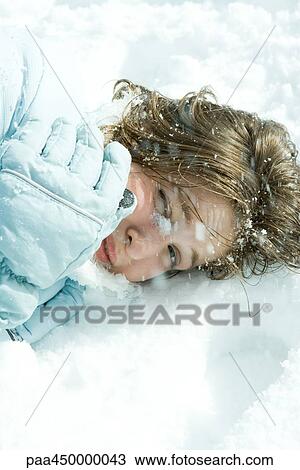 Teenage girl reclining in snow, looking at camera, close-up View Large Photo Image Stock Image - Teenage girl reclining in snow, looking at camera, close-up. Fotosearch