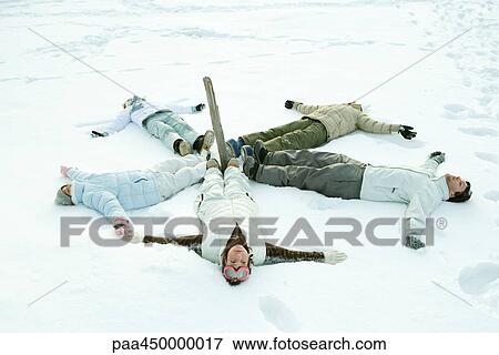 Young friends lying on ground in circle around wooden post View Large Photo Image Stock Photo - Young friends lying on ground in circle around wooden post. Fotosearch