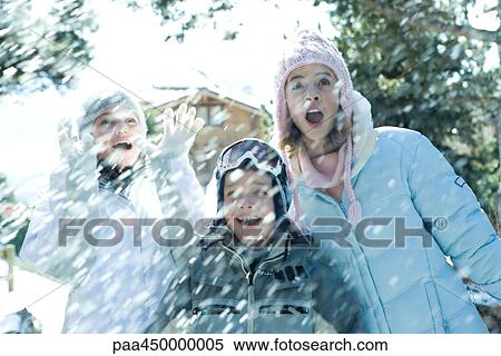 Young friends standing in falling snow, smiling, waist up View Large Photo Image Stock Photography - Young friends standing in falling snow, smiling, waist up. Fotosearch