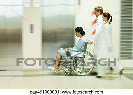 Hospital staff pushing man in wheelchair, blurred motion View Large Photo Image Stock Image - Hospital staff pushing man in wheelchair, blurred motion. Fotosearch