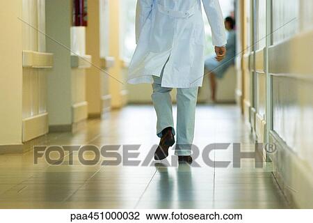 Male doctor walking in hospital corridor, cropped rear view View Large Photo Image Stock Image - Male doctor walking in hospital corridor, cropped rear view. Fotosearch