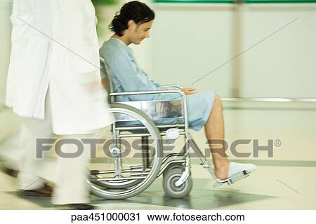 Medical staff pushing man in wheelchair, blurred motion View Large Photo Image Stock Image - Medical staff pushing man in wheelchair, blurred motion. Fotosearch