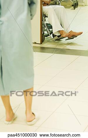 Patients in hospital, one standing, one sitting in wheelchair, cropped view View Large Photo Image Stock Image - Patients in hospital, one standing, one sitting in wheelchair, cropped view. Fotosearch