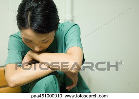 Woman resting head on arms, head down, close-up View Large Photo Image Stock Image - Woman resting head on arms, head down, close-up. Fotosearch