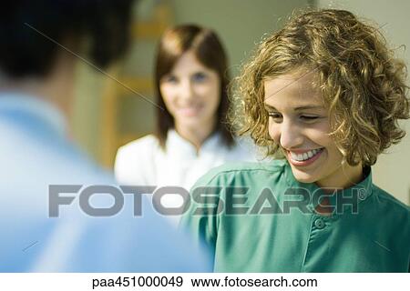 Young woman smiling, looking down, selective focus View Large Photo Image Stock Photo - Young woman smiling, looking down, selective focus. Fotosearch