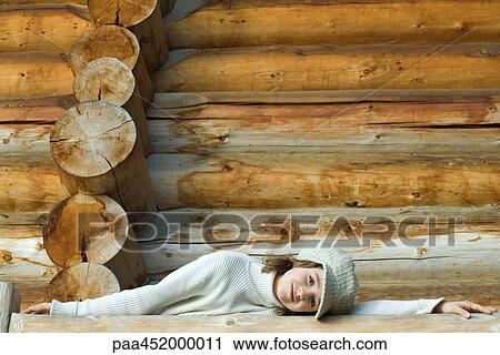 Girl leaning against railing in front of log cabin View Large Photo Image Stock Image - Girl leaning against railing in front of log cabin. Fotosearch
