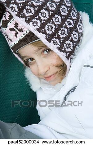 Girl wearing winter clothes, smiling at camera, portrait View Large Photo Image Picture - Girl wearing winter clothes, smiling at camera, portrait. Fotosearch