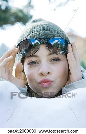 Preteen girl lifting sunglasses, puckering at camera View Large Photo Image Stock Image - Preteen girl lifting sunglasses, puckering at camera. Fotosearch