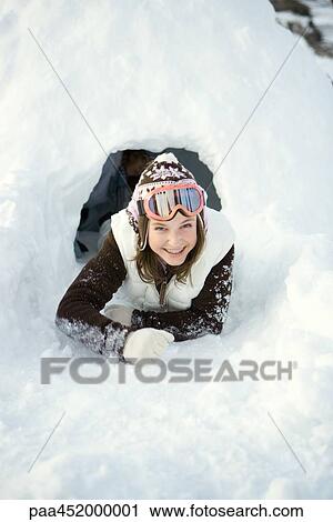 Teen girl crawling out of tunnel in snow View Large Photo Image Stock Image - Teen girl crawling out of tunnel in snow. Fotosearch