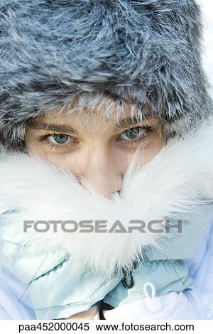 Teenage girl wearing fur hat, pushing fur collar over mouth, close-up portrait View Large Photo Image Stock Photography - Teenage girl wearing fur hat, pushing fur collar over mouth, close-up portrait. Fotosearch