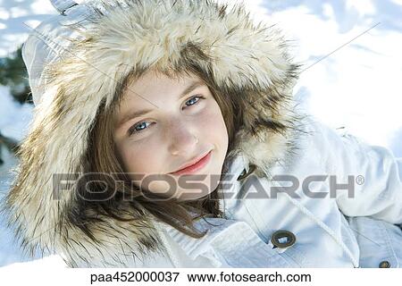 Teenage girl wearing parka in snow, portrait View Large Photo Image Stock Photo - Teenage girl wearing parka in snow, portrait. Fotosearch