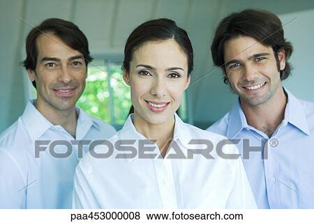 Businesswoman and two businessmen smiling at camera, head and shoulders, portrait View Large Photo Image Stock Photo - Businesswoman and two businessmen smiling at camera, head and shoulders, portrait. Fotosearch