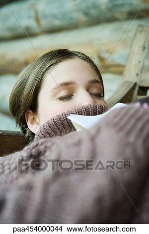 Teenage girl reclining, wearing turtleneck sweater, eyes closed View Large Photo Image Picture - Teenage girl reclining, wearing turtleneck sweater, eyes closed. Fotosearch
