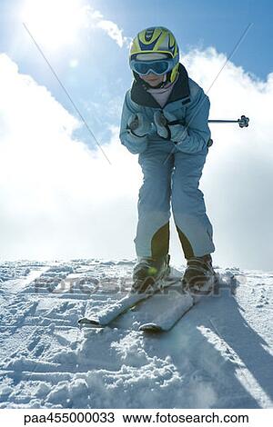 Young skier standing on top of hill, looking at camera, full length portrait View Large Photo Image Stock Image - Young skier standing on top of hill, looking at camera, full length portrait. Fotosearch