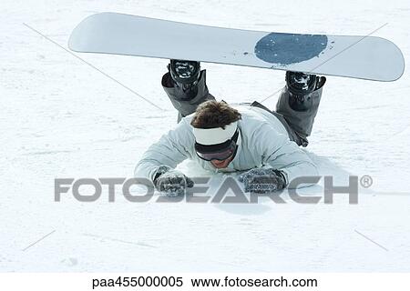 Young snowboarder fallen on the ground, full length View Large Photo Image Stock Photography - Young snowboarder fallen on the ground, full length. Fotosearch