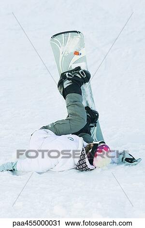 Young snowboarder lying on the ground, legs in the air, full length View Large Photo Image Stock Image - Young snowboarder lying on the ground, legs in the air, full length. Fotosearch