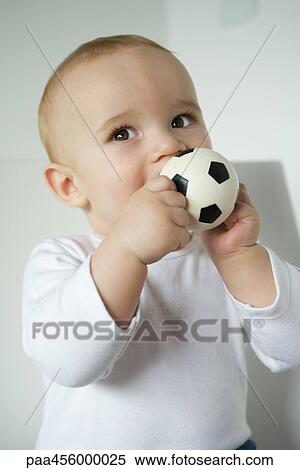 Baby biting ball, waist up View Large Photo Image Stock Photography - Baby biting ball, waist up. Fotosearch