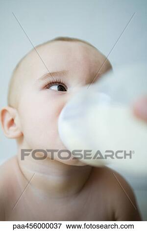Baby drinking milk from bottle, head and shoulders, selective focus View Large Photo Image Stock Photo - Baby drinking milk from bottle, head and shoulders, selective focus. Fotosearch