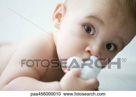 Baby looking at camera, wide eyes, holding rubber duck View Large Photo Image Stock Image - Baby looking at camera, wide eyes, holding rubber duck. Fotosearch