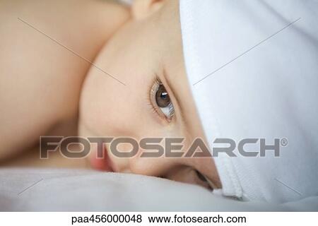 Baby lying on side, head and shoulders View Large Photo Image Stock Photo - Baby lying on side, head and shoulders. Fotosearch
