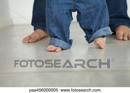 Baby taking first steps, cropped view of legs View Large Photo Image Stock Photography - Baby taking first steps, cropped view of legs. Fotosearch