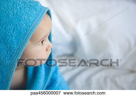 Baby wrapped in towel, looking away View Large Photo Image Stock Photo - Baby wrapped in towel, looking away. Fotosearch