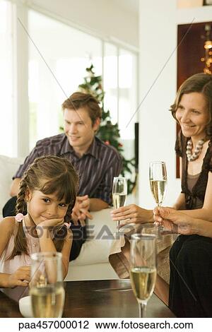 Adults drinking champagne, girl smiling at camera, hand under chin View Large Photo Image Stock Image - Adults drinking champagne, girl smiling at camera, hand under chin. Fotosearch