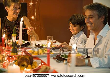 Family eating Christmas dinner, smiling View Large Photo Image Stock Photo - Family eating Christmas dinner, smiling. Fotosearch
