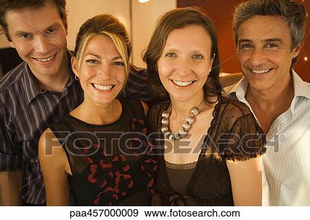 Four adult friends smiling at camera, group portrait View Large Photo Image Stock Photo - Four adult friends smiling at camera, group portrait. Fotosearch
