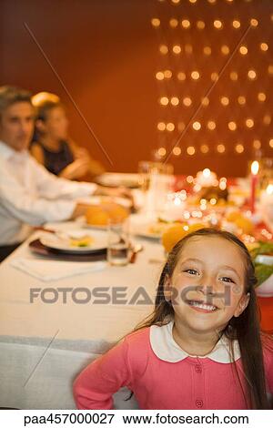Girl standing in front of Christmas dinner, smiling at camera View Large Photo Image Stock Photo - Girl standing in front of Christmas dinner, smiling at camera. Fotosearch
