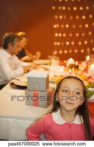 Girl standing in front of Christmas dinner, smiling, looking away View Large Photo Image Stock Photography - Girl standing in front of Christmas dinner, smiling, looking away. Fotosearch