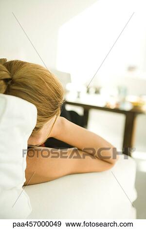 Woman sitting on couch, leaning on elbow, cropped rear view View Large Photo Image Stock Photo - Woman sitting on couch, leaning on elbow, cropped rear view. Fotosearch
