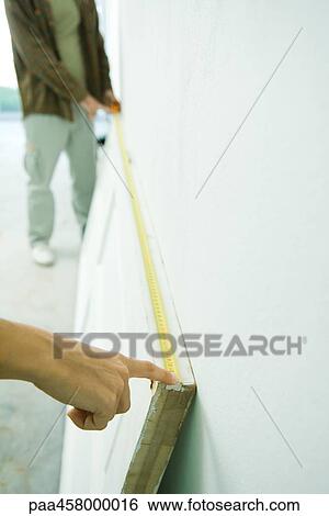 Man and woman measuring door with measuring tape, cropped view View Large Photo Image Stock Photograph - Man and woman measuring door with measuring tape, cropped view. Fotosearch