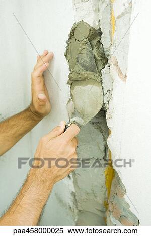 Man applying putty with trowel, cropped view of hands View Large Photo Image Stock Photography - Man applying putty with trowel, cropped view of hands. Fotosearch
