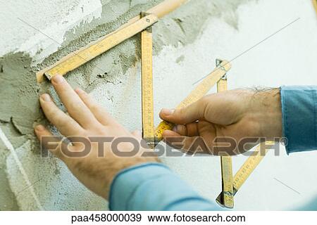 Man measuring with folding ruler, cropped view of hands View Large Photo Image Stock Photo - Man measuring with folding ruler, cropped view of hands. Fotosearch
