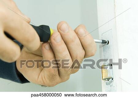 Man repairing door lock with screwdriver, cropped view of hands View Large Photo Image Stock Image - Man repairing door lock with screwdriver, cropped view of hands. Fotosearch