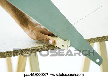 Man sawing wood, cropped view of hand View Large Photo Image Stock Photo - Man sawing wood, cropped view of hand. Fotosearch