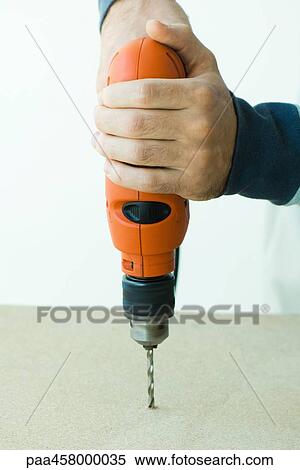 Man using drill, cropped view of hands View Large Photo Image Stock Photography - Man using drill, cropped view of hands. Fotosearch