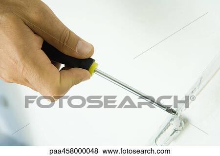 Man using screwdriver, cropped view of hand View Large Photo Image Stock Photo - Man using screwdriver, cropped view of hand. Fotosearch