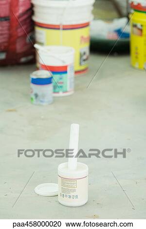 Paint can on the ground, open, painting materials in background View Large Photo Image Stock Image - Paint can on the ground, open, painting materials in background. Fotosearch