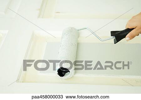 Woman painting door with paint roller, cropped view of hand View Large Photo Image Stock Image - Woman painting door with paint roller, cropped view of hand. Fotosearch