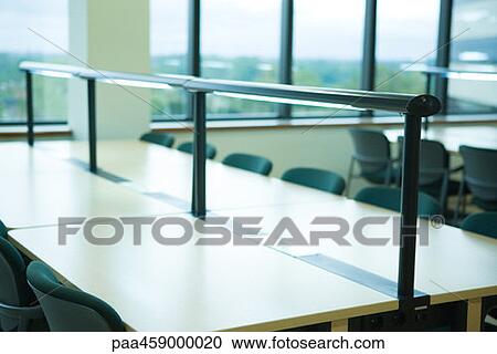 Stock Image - Classroom with desks, empty seats. Fotosearch