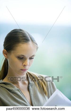 Female student looking at book, cropped view View Large Photo Image Stock Photograph - Female student looking at book, cropped view. Fotosearch